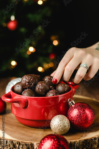 peanut butter chocolate truffles in a red bowl on a wood table