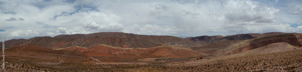 The arid desert. Altiplano. Panorama view of the dry land, valley and colorful mountains under a beautiful sky. The arid desert. Altiplano. Panorama view of the dry land, valley and colorful mountains under a beautiful sky.