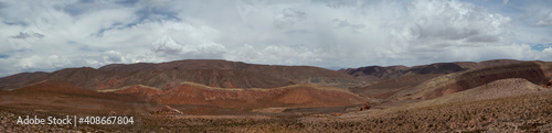 The arid desert. Altiplano. Panorama view of the dry land, valley and colorful mountains under a beautiful sky.