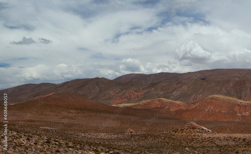 The arid desert. Panorama view of the dry land, valley and mountains under a beautiful sky high in the Andes mountain range. The arid desert. Panorama view of the dry land, valley and mountains under a beautiful sky high in the Andes mountain range.