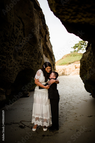 Mother & Son Embracing on Beach in San Diego photo