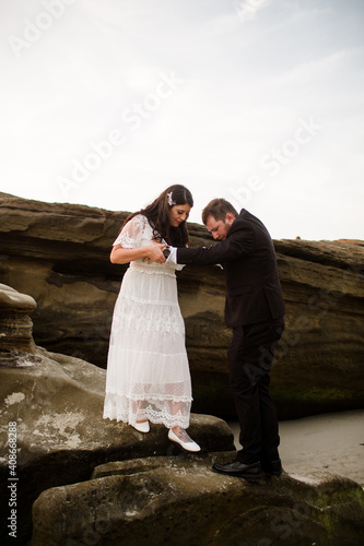 Wallpaper Mural Newlyweds Climbing off of Rock on Beach in San Diego Torontodigital.ca
