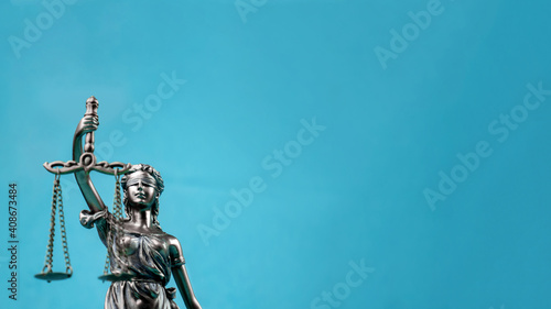 Lady Justice isolated on blue background. Symbol of law or lawyer.