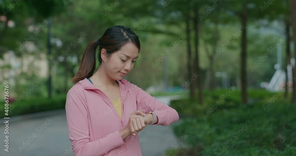 Woman use of smart watch at park Woman use of smart watch at park