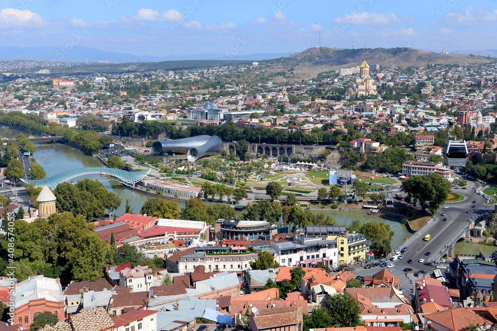 Tbilisi, Georgia overview. Modern landmarks of the city visible including the Bridge of Peace over Kura River, Rike Park and Presidential Palace.