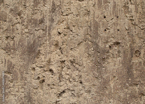 Old retro scrutched yellow brown sandstone wall texture background.