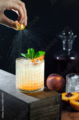 whiskey cocktail with peaches and mint