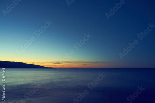 The Mediterranean coast of Crete is descended in fog on the horizon.