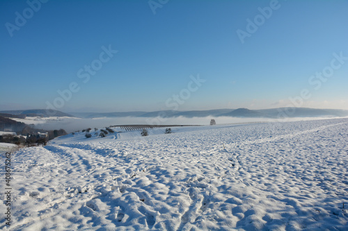 Snow landscape with fields and fog and sky