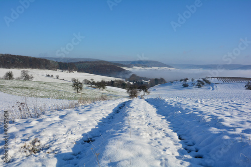 Winter landscape with fields and fog in the valley, with a lot of snow