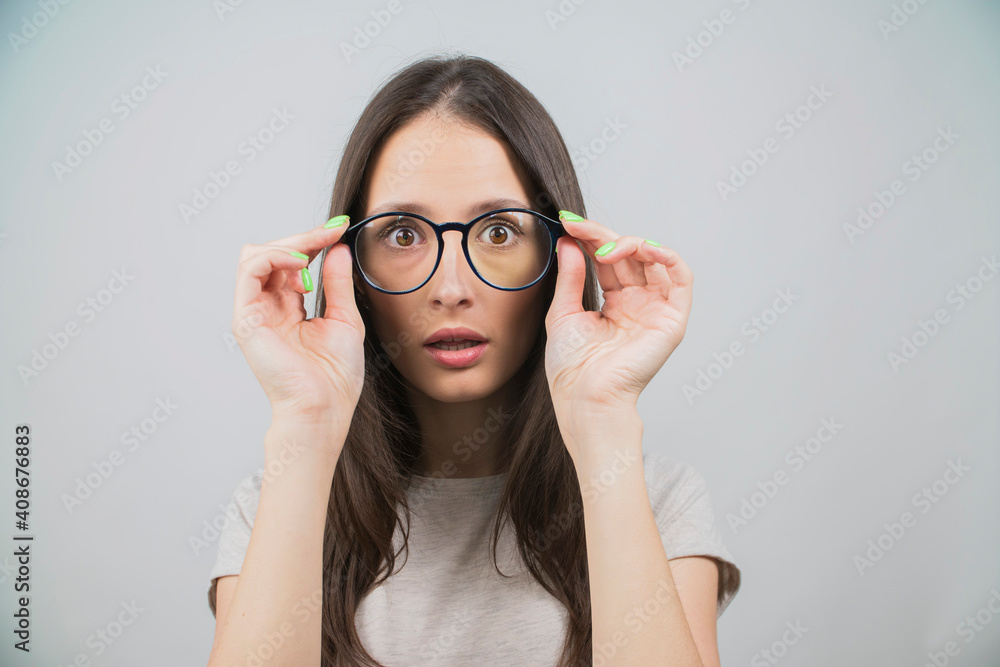portrait of a young girl surprised on a white background portrait of a young girl surprised on a white background