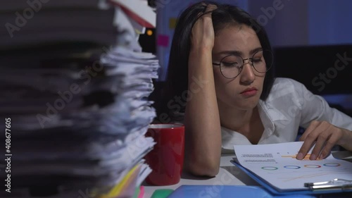 Stressed businesswoman working late at night in the office