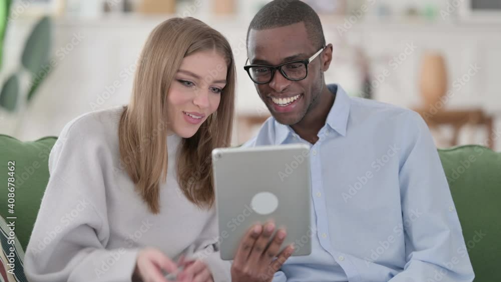 Online Video Chat on Tablet by Mixed Race Couple, Home Online Video Chat on Tablet by Mixed Race Couple, Home