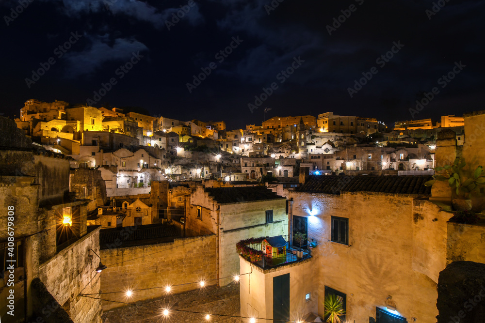 Night view of the ancient city of Matera Italy including the ancient cave homes in the Basilicata region of Matera, Italy.