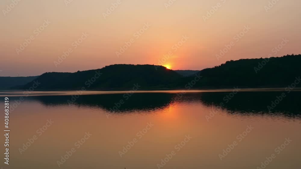 Time-lapse of Chinese landscape at sunset, lake at dusk and silhouette of mountains Time-lapse of Chinese landscape at sunset, lake at dusk and silhouette of mountains