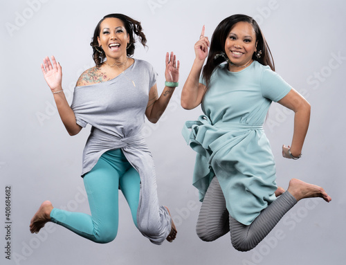 Two multi ethinic woman jumping for joy photo