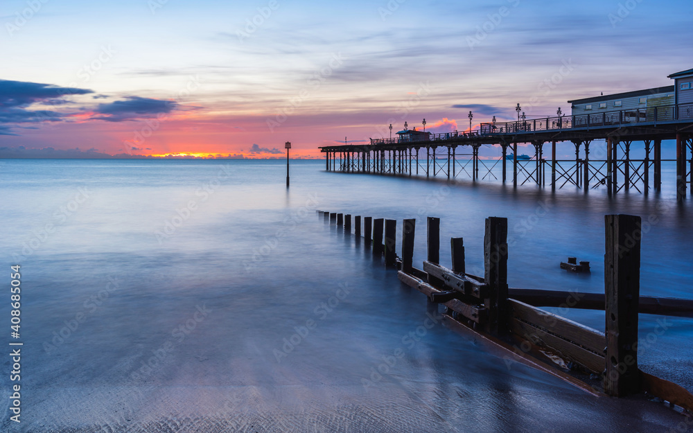 Sunrise in long time exposure of Grand Pier in Teignmouth in Devon in England, Europe