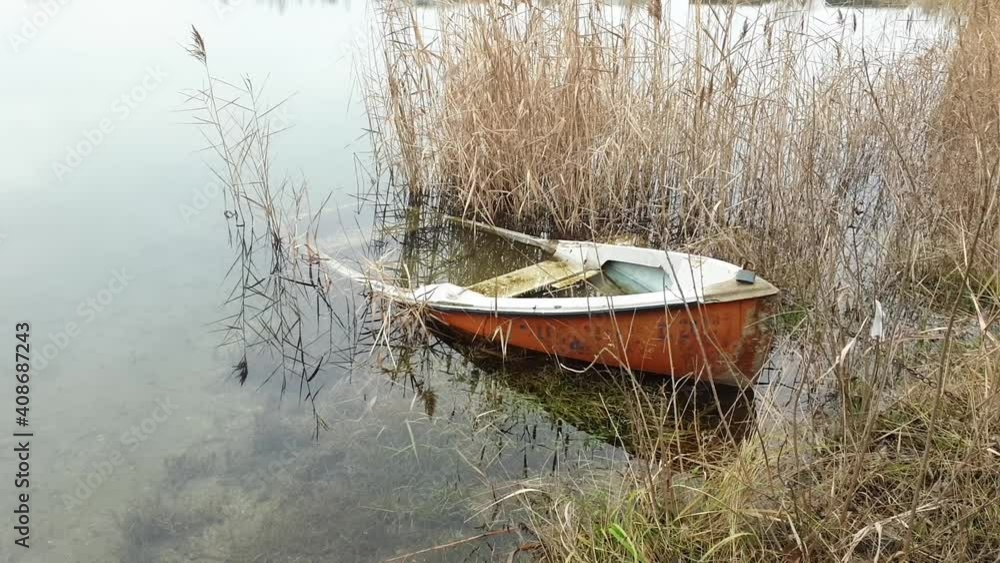 panning shot of a sunken rowboat in a lake. panning shot of a sunken rowboat in a lake.