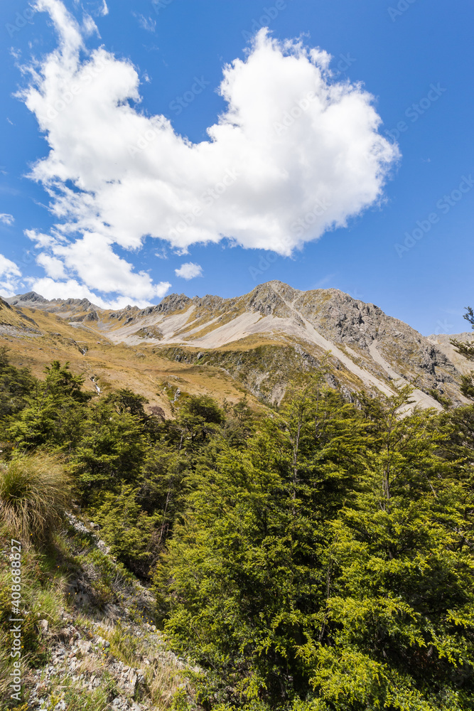 cumulus clouds above mountain range in Rainbow ski area of Southern Alps in New Zealand