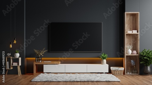 Mockup a TV wall mounted in a dark room with a black wall.
