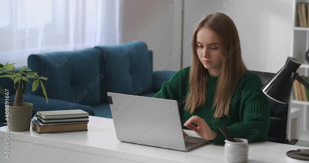 female student is using laptop at home for e-learning, distance online education, young woman is working with notebook female student is using laptop at home for e-learning, distance online education, young woman is working with notebook