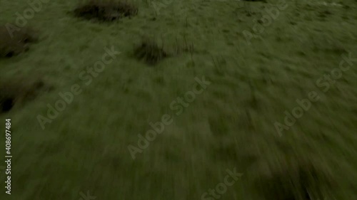 Low flying drone establish shot tilting up to reveal Walsh hills with small snow caps in winter. photo