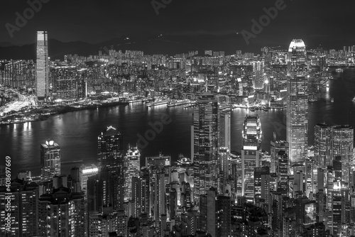 Aerial view of Victoria Harbor of Hong Kong city at night © leeyiutung