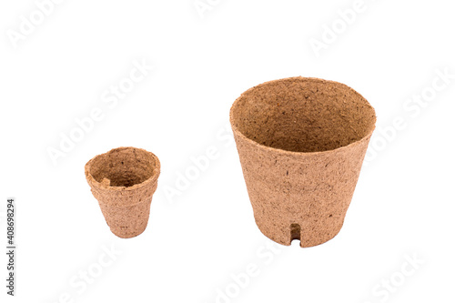 Big and Small ecology flower pots made from coconut fiber on white table.