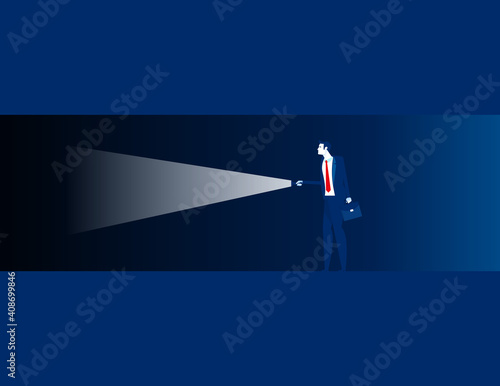 People holding a flashlight to explore the dark cave