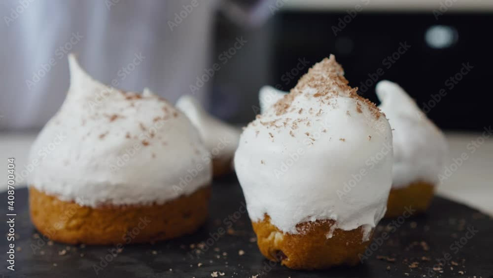 The cook covers the cake with chocolate chips. Traditional Easter cake with protein cream. Easter cake The cook covers the cake with chocolate chips. Traditional Easter cake with protein cream. Easter cake