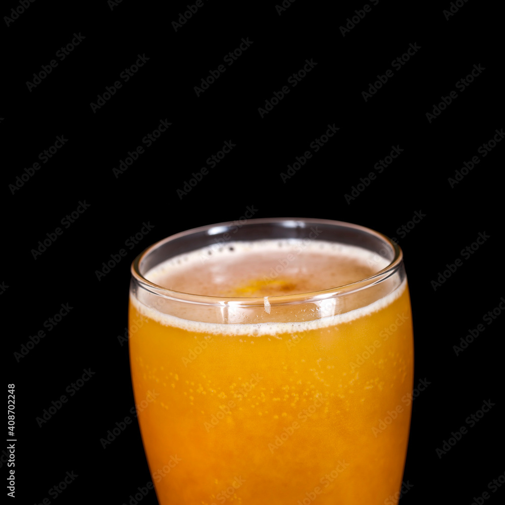 Glass of craft beer with passion fruit isolated on a black background. Glass of craft beer with passion fruit isolated on a black background.