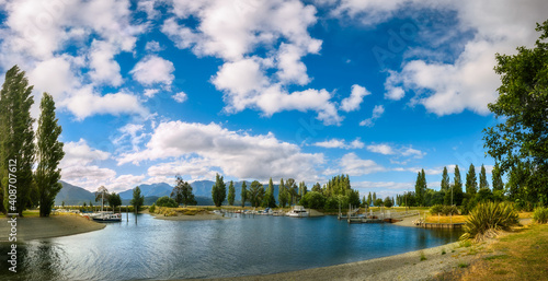 Te Anau Boating Club Marina Panorama on the shore of Lake Te Anau in New Zealand, South Island on a beautiful afternoon at golden hour.