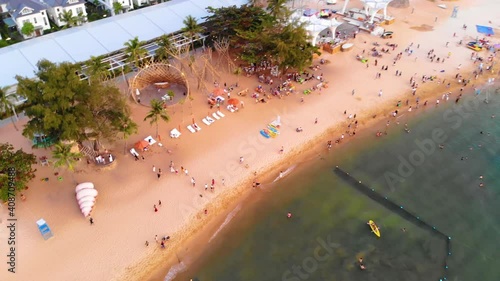 Aerial view of Sunset in Phu Quoc beach with nice view. Tourists, sunbeds and umbrellas on beautiful day in Sanato beach, Phu Quoc island, Vietnam photo