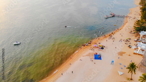 Aerial view of Sunset in Phu Quoc beach with nice view. Tourists, sunbeds and umbrellas on beautiful day in Sanato beach, Phu Quoc island, Vietnam photo