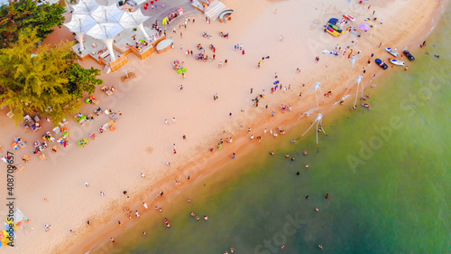 Aerial view of Sunset in Phu Quoc beach with nice view. Tourists, sunbeds and umbrellas on beautiful day in Sanato beach, Phu Quoc island, Vietnam photo