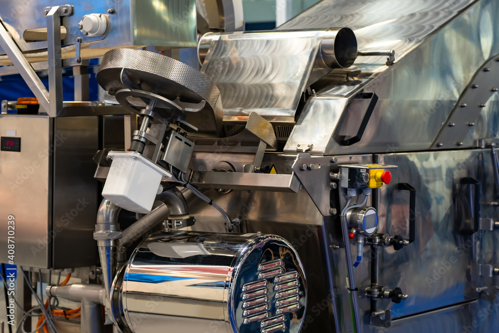 Fragment of a filling and packaging line in food industry. Filling and packaging machine. It is designed for processing seafood. Fragment of a conveyor belt for food production. Food industry Fragment of a filling and packaging line in food industry. Filling and packaging machine. It is designed for processing seafood. Fragment of a conveyor belt for food production. Food industry