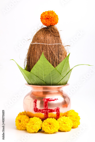 Indian festival akshaya tritiya concept : Decorative kalash with coconut and leaf with floral decoration photo