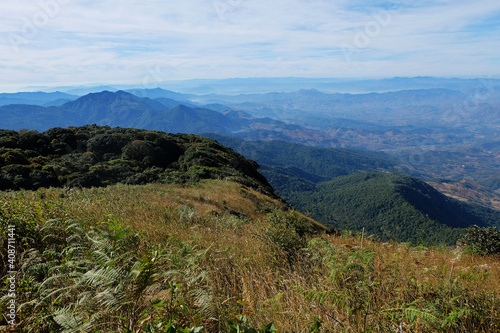 Natural landscape of green mountain range with cloudy blue sky