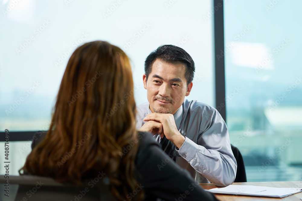 asian hr manager interviewing business woman