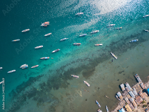 Boats on the coast near fishermen's village view from drone
