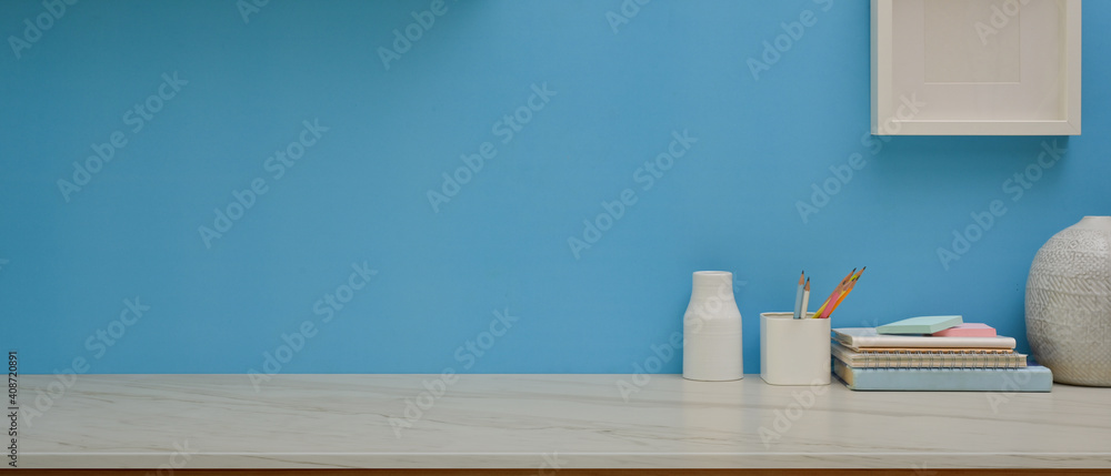 Obraz premium Study table with stationery, decorations and copy space in home office room