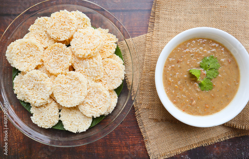 Crispy rice cracker served with minced pork, shrimp and peanut dipping sauce - Thai appetizer called Kao Tung Na Tang photo