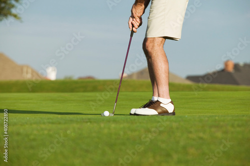 Man putting during a game of golf