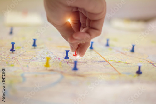 Soft focus hand holding paper pin on blur perspective road map,copy space.filter color effect.