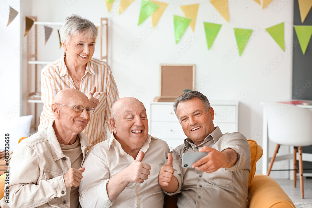 Fototapeta premium Senior people video chatting at home