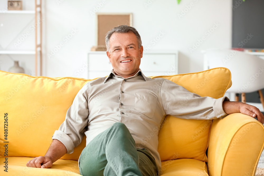 Fototapeta premium Senior man sitting on sofa at home