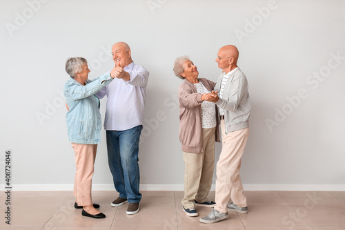 Senior couples dancing near...