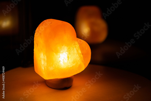 Light in heart shape on small table.