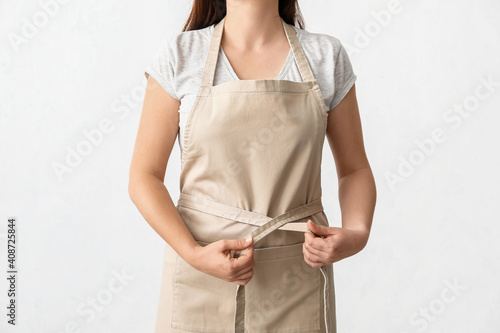 Valokuvatapetti Female waiter wearing apron on white background