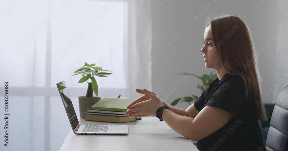 female coach is consulting online, speaking to webcam of laptop, explaining and gesticulating, webinar and lecture of modern specialist female coach is consulting online, speaking to webcam of laptop, explaining and gesticulating, webinar and lecture of modern specialist